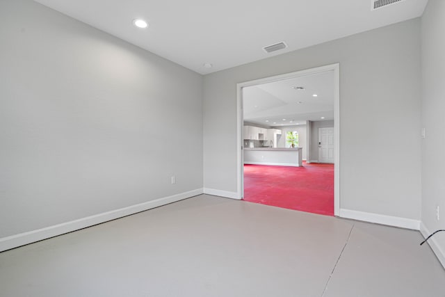 unfurnished room with concrete floors