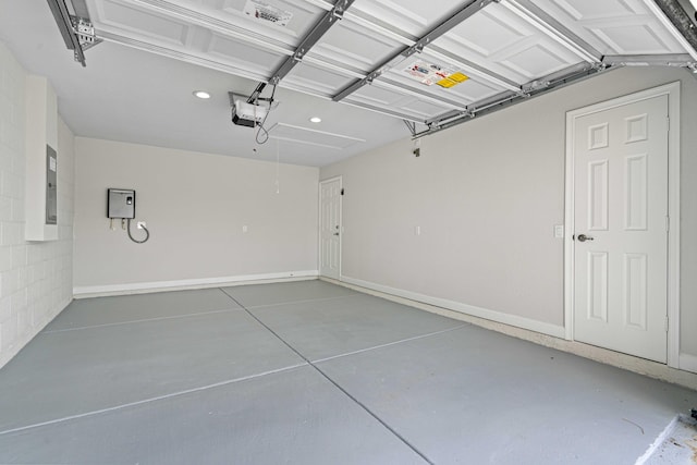 garage with electric panel and a garage door opener