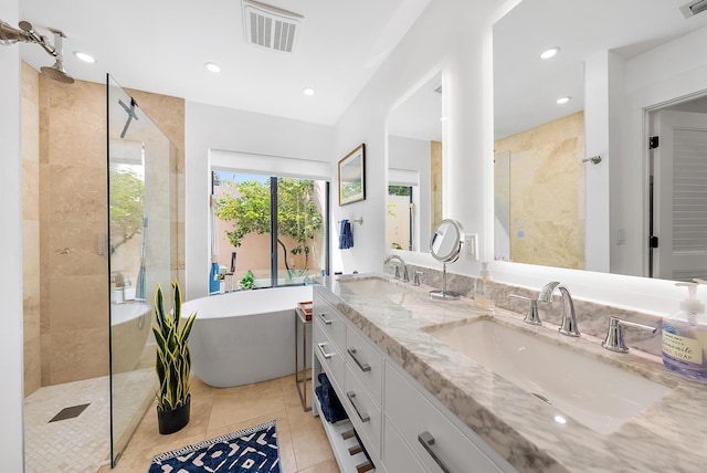 bathroom with tile patterned floors, vanity, and plus walk in shower