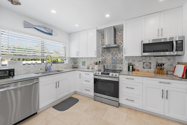 1484 Via Del Sol, Jupiter, FL 33477 - kitchen with appliances with stainless steel finishes, wall chimney range hood, backsplash, light tile patterned floors, and white cabinets