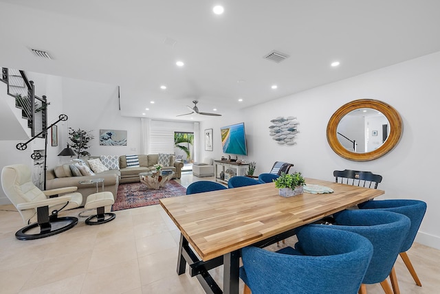 tiled dining space featuring ceiling fan