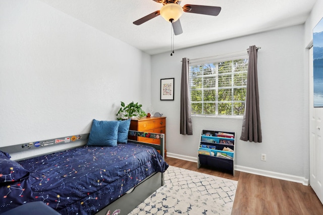 bedroom with hardwood / wood-style flooring and ceiling fan