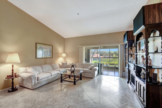 living room featuring light tile patterned floors and vaulted ceiling