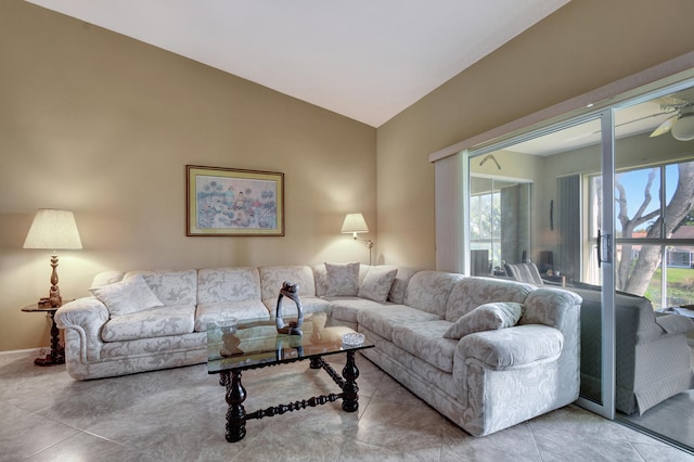 living room featuring a healthy amount of sunlight, tile patterned floors, and vaulted ceiling