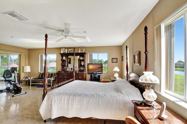 bedroom featuring multiple windows and ceiling fan