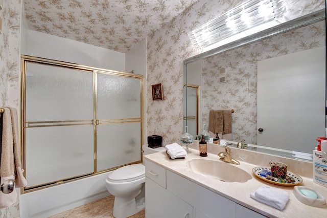 full bathroom featuring tile patterned flooring, enclosed tub / shower combo, toilet, and vanity