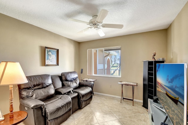 tiled living room featuring ceiling fan and a textured ceiling