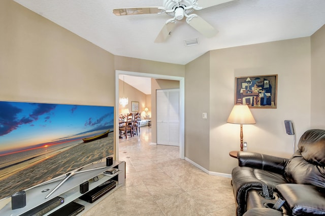 living room with light tile patterned flooring and ceiling fan