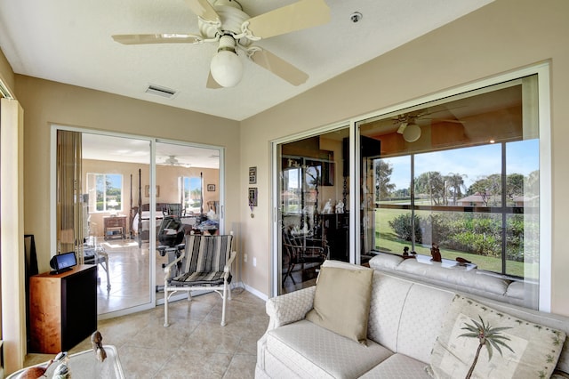 interior space with ceiling fan