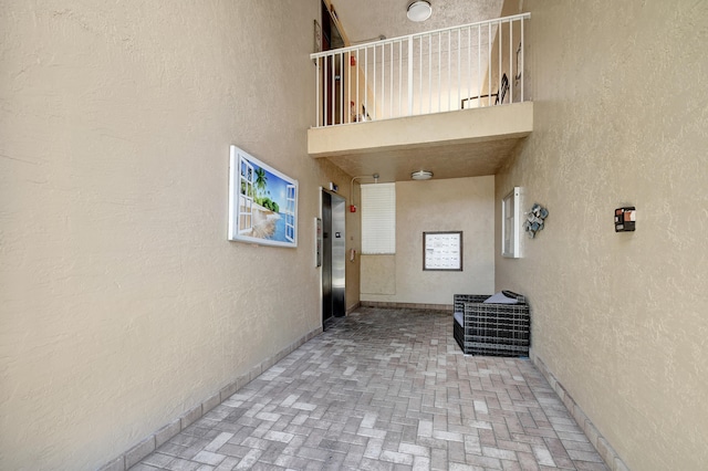 interior space with a balcony and elevator