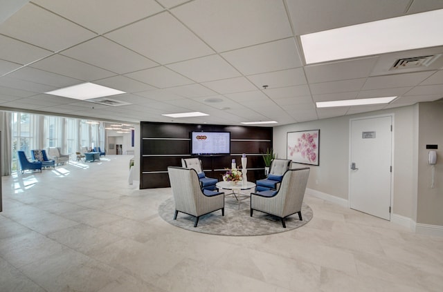 living room with a drop ceiling