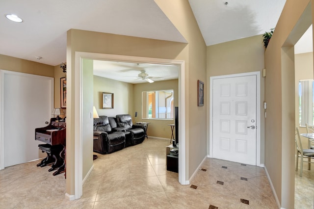 entrance foyer with ceiling fan and light tile patterned floors