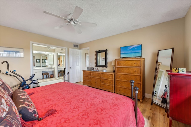 bedroom featuring hardwood / wood-style floors, a textured ceiling, and ceiling fan