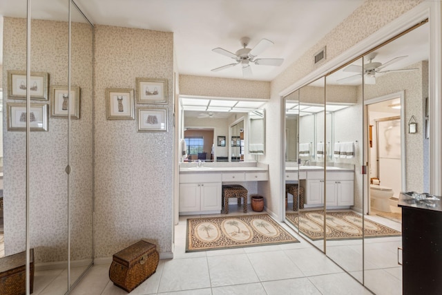 bathroom featuring tile patterned floors, ceiling fan, vanity, and toilet