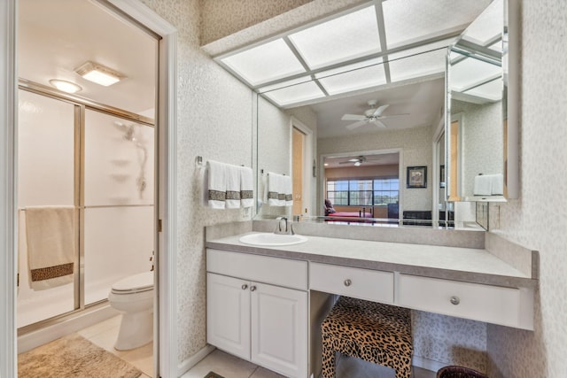 bathroom featuring vanity, ceiling fan, tile patterned flooring, toilet, and a shower with shower door