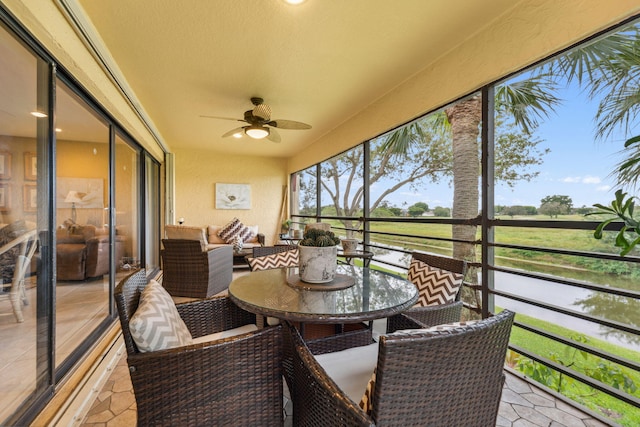 sunroom featuring ceiling fan