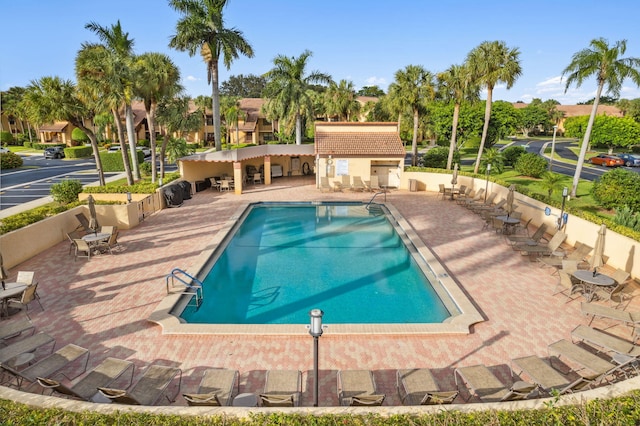 view of swimming pool with a patio and an outdoor structure