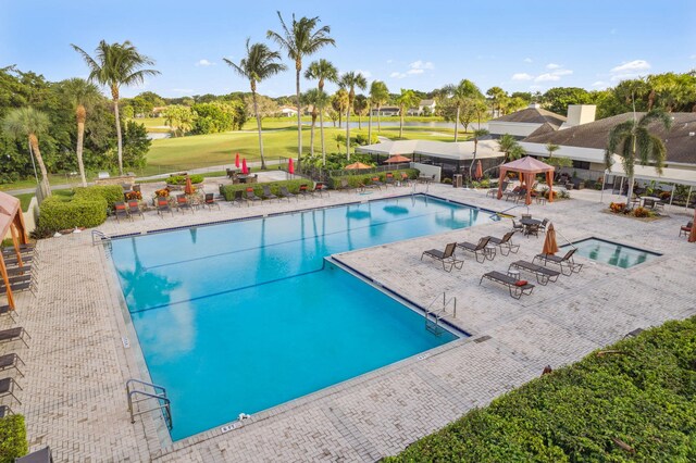 view of swimming pool featuring a gazebo, a patio, and a hot tub