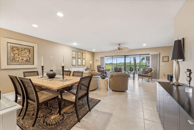 tiled dining space with ceiling fan