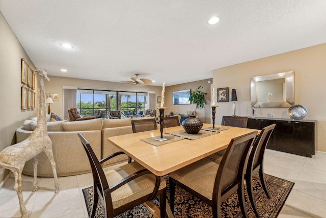 tiled dining area featuring ceiling fan