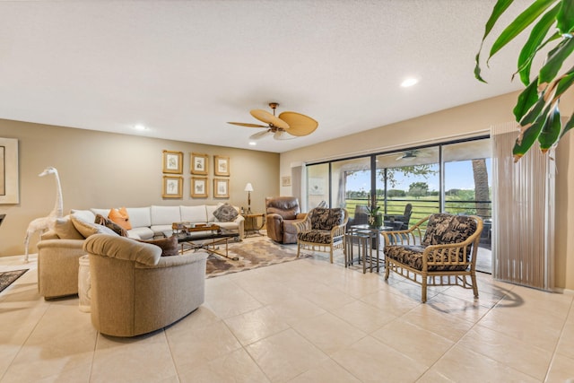 tiled living room featuring a textured ceiling and ceiling fan