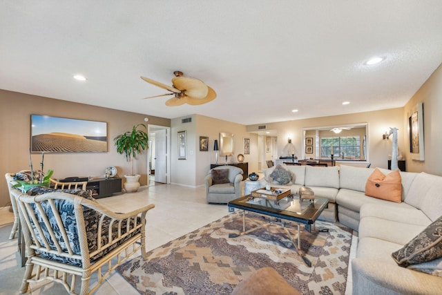 tiled living room with ceiling fan