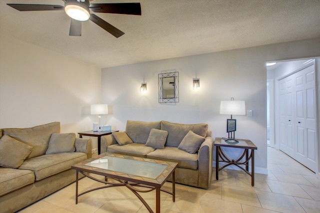 tiled living room featuring ceiling fan and a textured ceiling