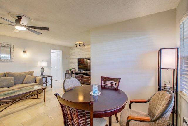 dining room with light tile patterned floors, a textured ceiling, and ceiling fan