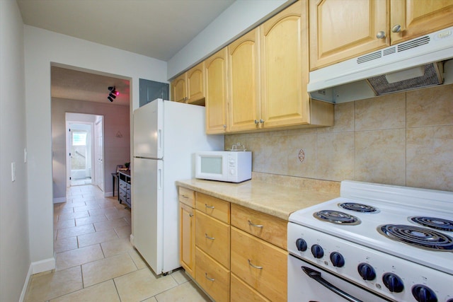 kitchen with light tile patterned flooring, light brown cabinetry, white appliances, and backsplash