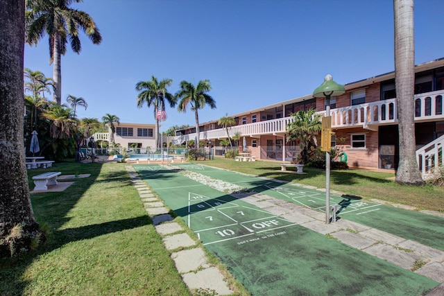 view of property's community featuring a yard