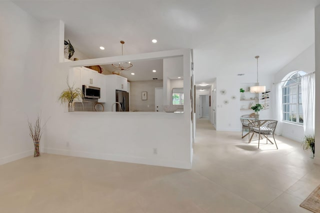 kitchen featuring pendant lighting, a notable chandelier, a healthy amount of sunlight, and appliances with stainless steel finishes