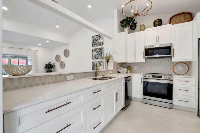 kitchen with decorative backsplash, white cabinetry, sink, and appliances with stainless steel finishes