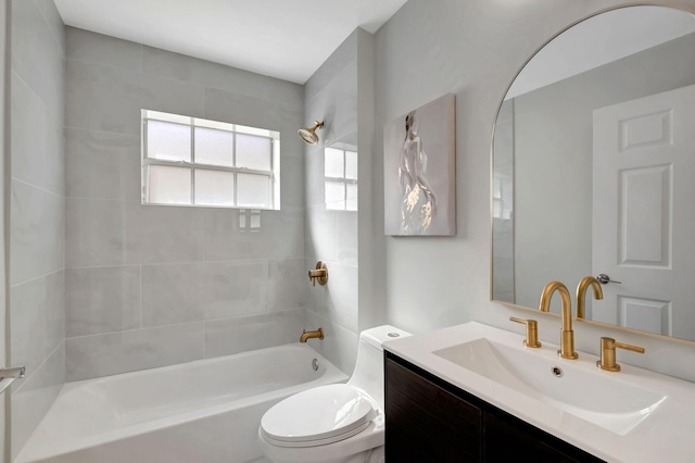 full bathroom featuring vanity, toilet, and tiled shower / bath