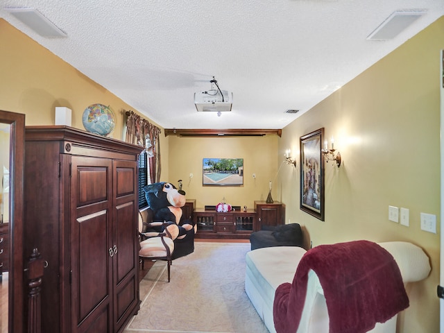 interior space with light colored carpet and a textured ceiling