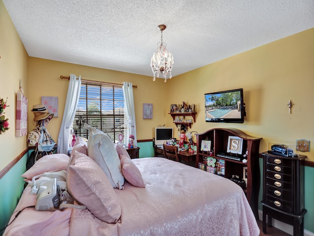 bedroom featuring a notable chandelier and a textured ceiling