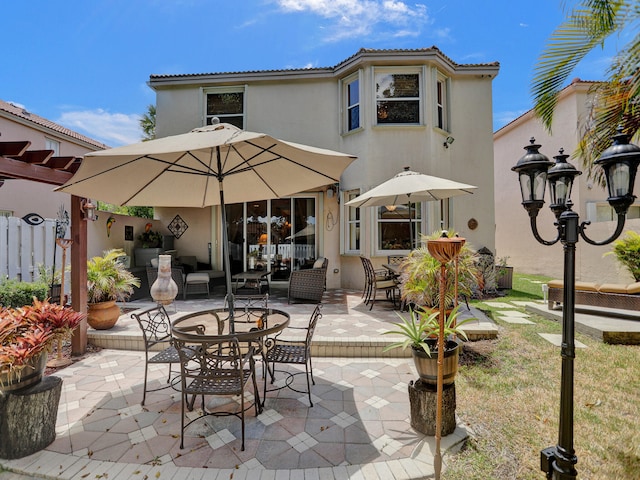 rear view of property featuring a patio area