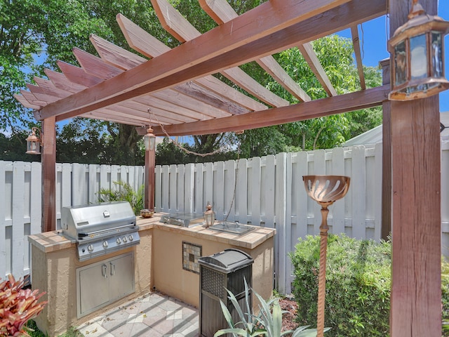 view of patio with a pergola and area for grilling