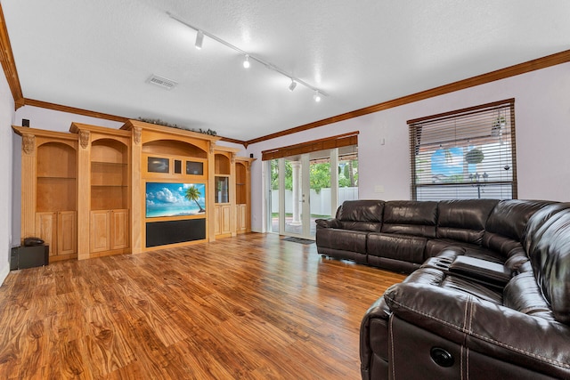 living room with french doors, hardwood / wood-style floors, track lighting, a textured ceiling, and crown molding