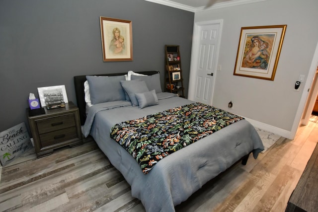 bedroom featuring wood-type flooring and ornamental molding