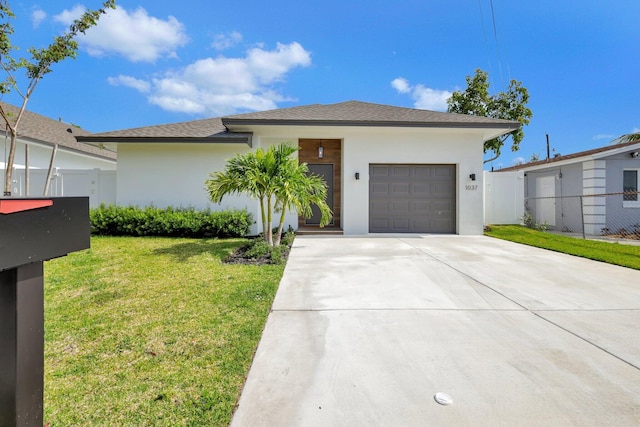 view of front of house featuring a garage and a front yard