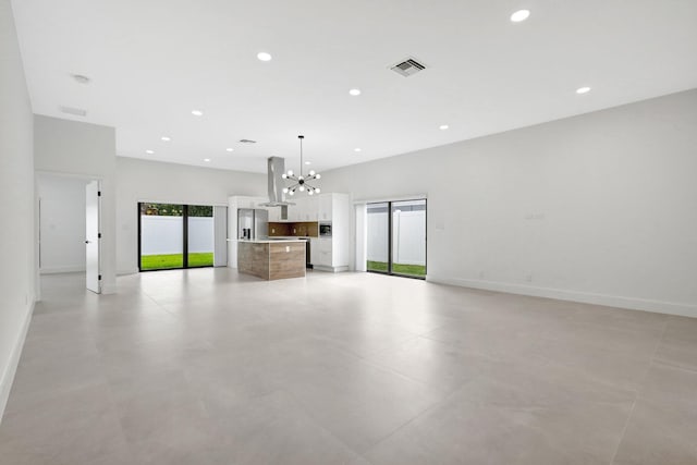 unfurnished living room with a notable chandelier