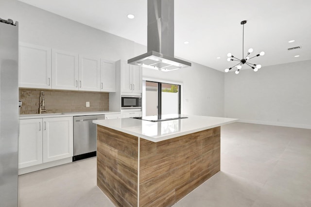 kitchen featuring a kitchen island, island exhaust hood, appliances with stainless steel finishes, and white cabinets