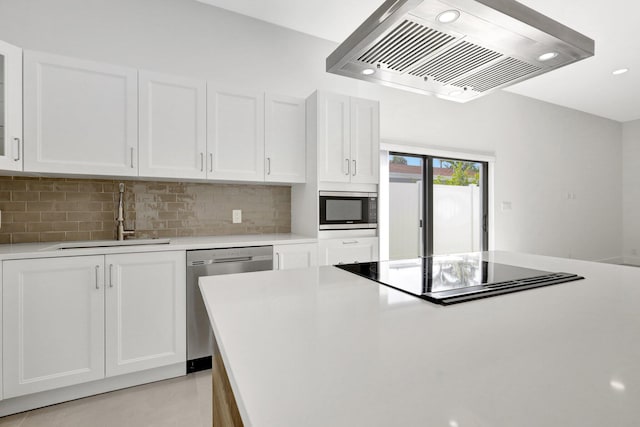 kitchen with range hood, appliances with stainless steel finishes, decorative backsplash, sink, and white cabinets