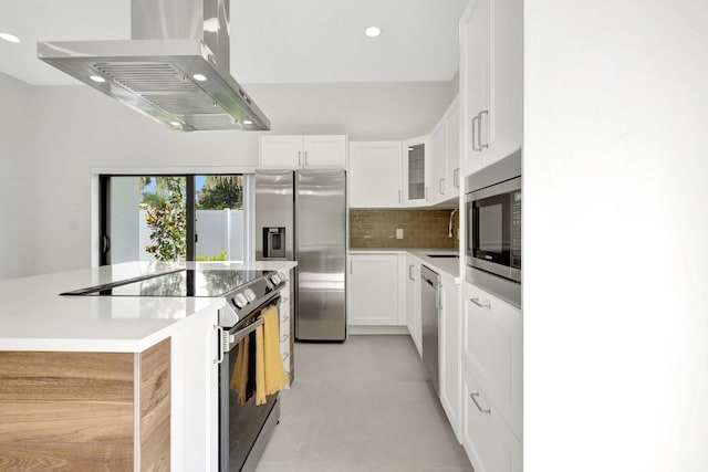 kitchen with sink, appliances with stainless steel finishes, backsplash, ventilation hood, and white cabinets