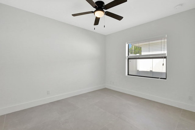 empty room with light tile patterned floors and ceiling fan