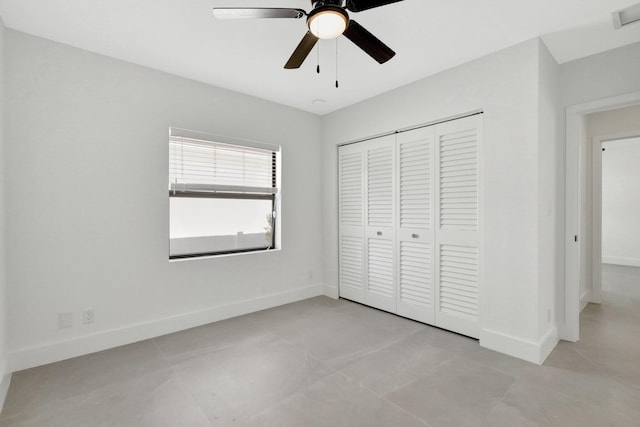 unfurnished bedroom featuring a closet, light tile patterned flooring, and ceiling fan