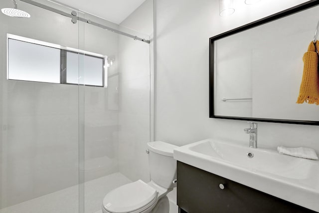 bathroom featuring toilet, vanity, and walk in shower