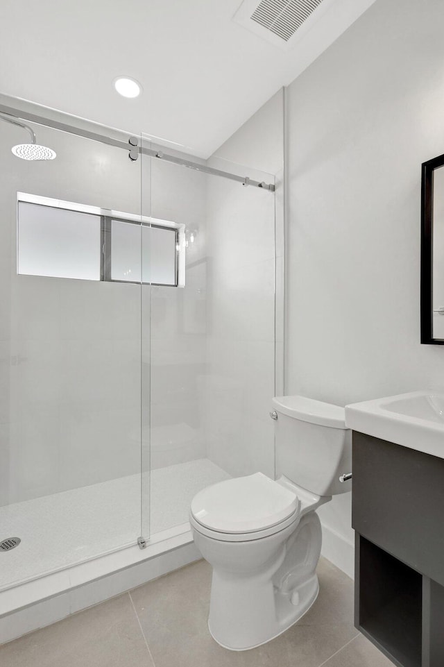 bathroom with tile patterned flooring, vanity, toilet, and a shower with shower door