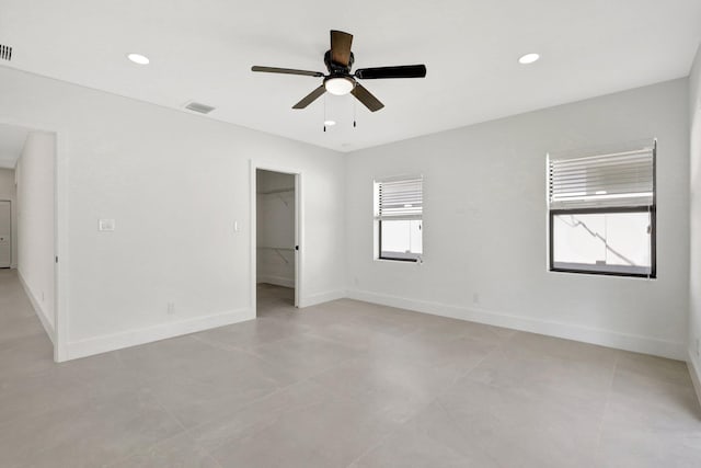 unfurnished room with a wealth of natural light and ceiling fan