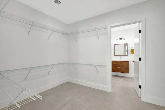 spacious closet featuring light tile patterned flooring